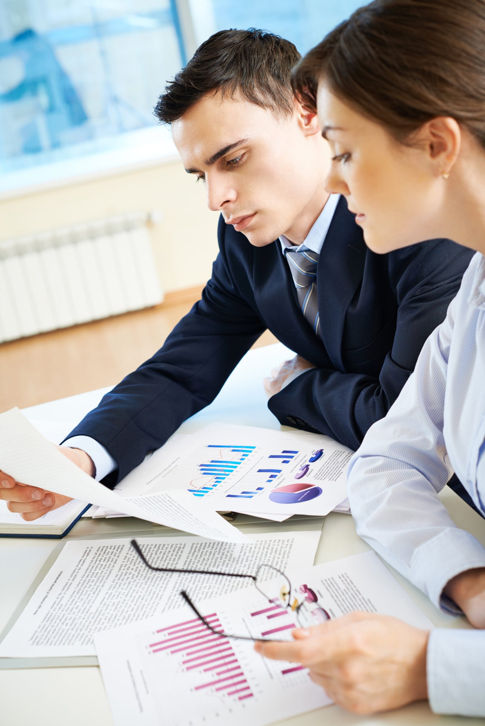 Business partners looking through papers at meeting