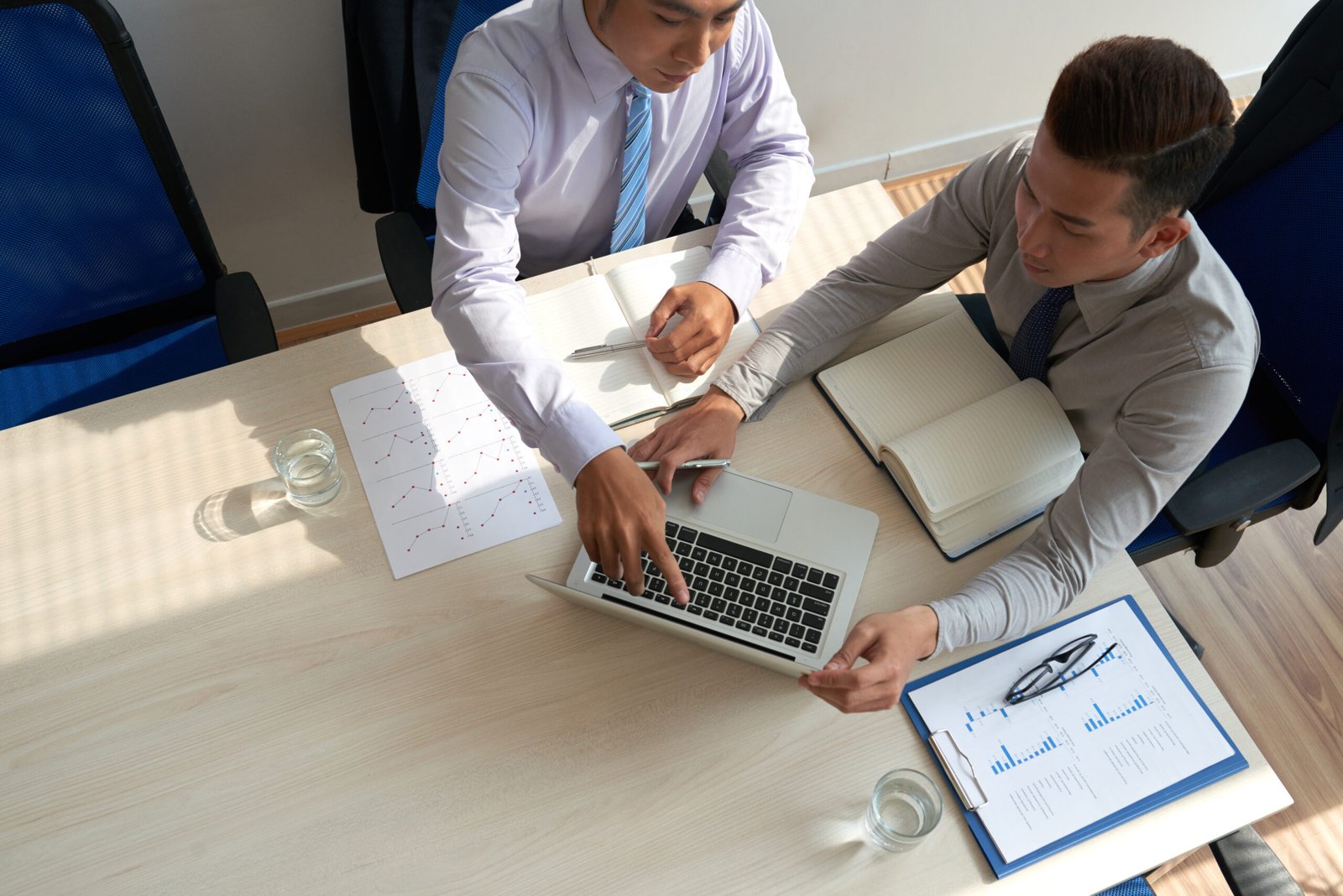 Team of business executives discussing various issues at the meeting, view from above